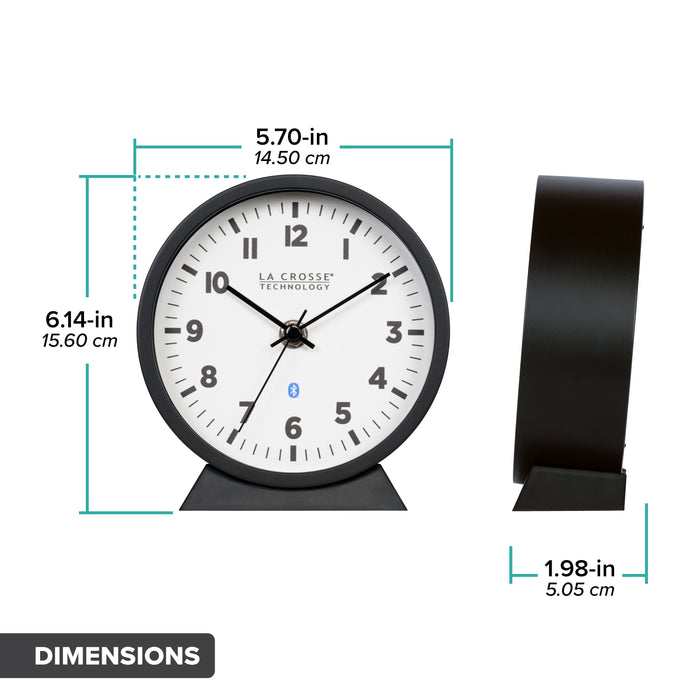 Dimension image in inches and centimeters for the 437-3816 Insta-Set Table/Wall Clock with Bluetooth® Technology featuring a white dial with bold black numerals, black metal hands, and a black frame with removable base for tabletop or wall hanging placement. The clock measures 5.70 in L x 1.98 in W x 6.14 in H.