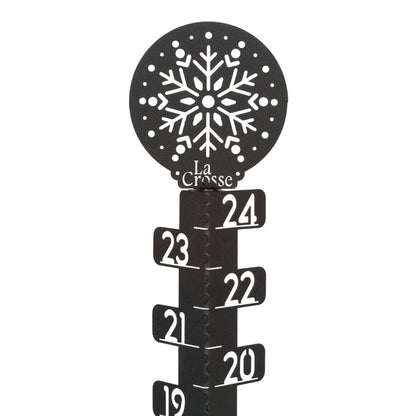 Detail view of the ornamental snowflake accent at the top of the 139-4686 metal snow gauge showing the La Corsse logo and inch measurement markings laser cut in the metal