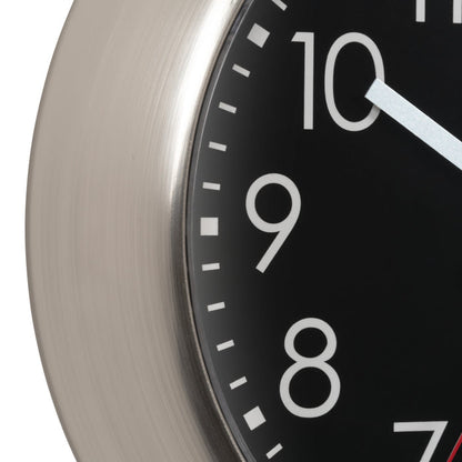 Close-up of a clock face with white numbers on a black background