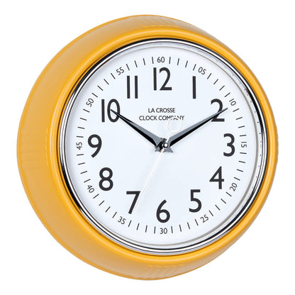 Right-facing image of the 404-3024MY 9.5-inch Diner Clock – Mustard Yellow. The clock features a retro-style mustard yellow frame with a white dial, chrome bezel, black numbers and minute markings, black metal hands, and a silver second hand.