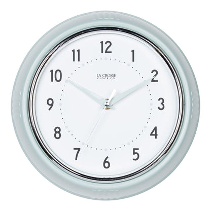 Head-on image of the 404-3024PH 9.5-inch Diner Wall Clock - Pistachio. The clock features an off-white dial with black numbers, pistachio hour dots, pistachio hour and minute hands, and a silver accent second hand set within a vintage-retro pistachio green frame.