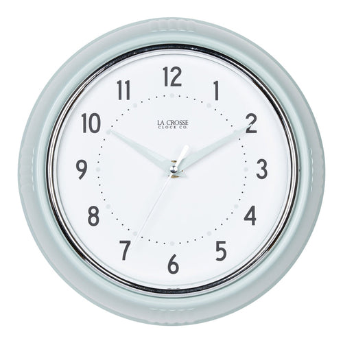 Head-on image of the 404-3024PH 9.5-inch Diner Wall Clock - Pistachio. The clock features an off-white dial with black numbers, pistachio hour dots, pistachio hour and minute hands, and a silver accent second hand set within a vintage-retro pistachio green frame.