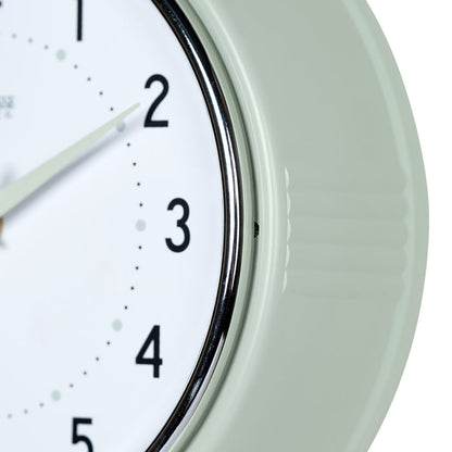 Close-up frame image of the 404-3024PH 9.5-inch Diner Wall Clock - Pistachio. The clock features an off-white dial with black numbers, pistachio hour dots, pistachio hour and minute hands, and a silver accent second hand set within a vintage-retro pistachio green frame.