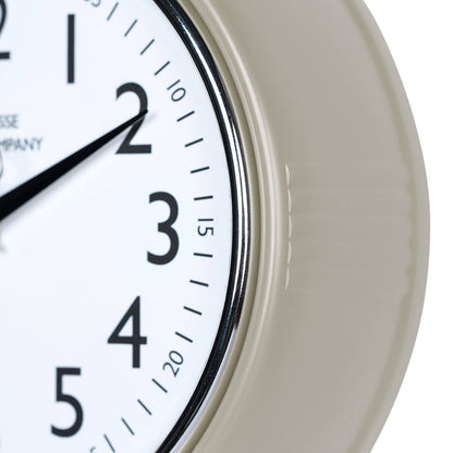 Close-up frame image of the 404-3024TP 9.5-inch Diner Clock – Taupe, features a retro-style taupe frame with a white dial, chrome bezel, black numbers and minute markings, black metal hands, and a silver second hand.