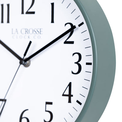 Close-up image of the Sage Green frame of the 404-3025G 10-inch Basic Decor Wall Clock with a white dial,  black numbers, hour, minute, and second hands