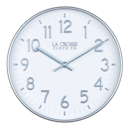 Head on view of view of the 404-3027B Tovi modern wall clock showing a white dial with silver Arabic numbers and a flush mount silver case  and matching silver hour and minute hands
