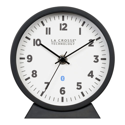 Head-on image of the 437-3816 Insta-Set Table/Wall Clock with Bluetooth® Technology featuring a white dial with bold black numerals, black metal hands, and a black frame with removable base for tabletop or wall hanging placement.