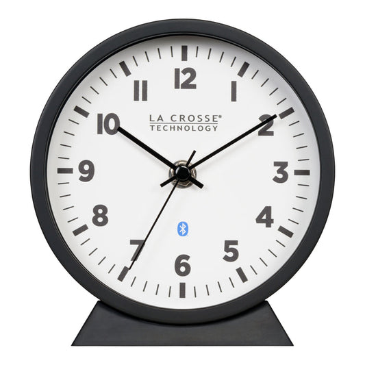 Head-on image of the 437-3816 Insta-Set Table/Wall Clock with Bluetooth® Technology featuring a white dial with bold black numerals, black metal hands, and a black frame with removable base for tabletop or wall hanging placement.