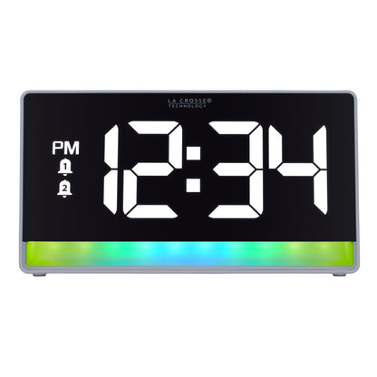 Hed-on image of the 617-149 Digital Alarm Clock with Color Changing Glow Light, the alarm clock features a white case, a color-changing bar at the base shown in blues and greens, and a black display with white digits.