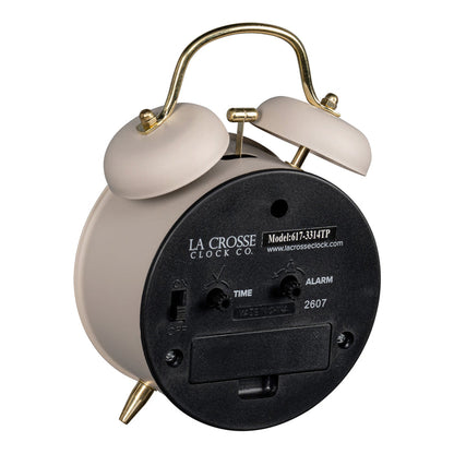 Angled back image of the 617-3314TP Metal Twin Bell Alarm Clock – Taupe, showing the battery compartment, knobs, and the on/off switch.