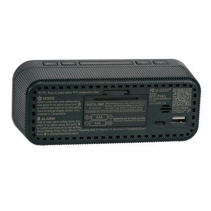 Angled back view of the 617-714G Insta-Set Digital LED Alarm Clock with Bluetooth® Technology - Green, showing the buttons, the battery compartment, the USB-C power port, the USB-A charging port, and the operating instructions.