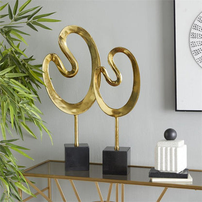 COSMOLIVING BY COSMOPOLITAN GOLD MARBLE ABSTRACT SCULPTURE WITH BLACK BASE